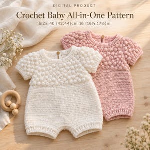 May include: Digital product crochet baby all-in-one pattern with text size 40 (42:44) cm 16 (16 1/2:17 1/2) in. Two crochet baby rompers, one white and one pink, featuring a textured bobble stitch bodice, short sleeves, and a single wooden button at the neck.