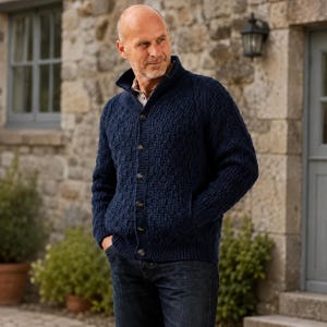 May include: A navy blue knit cardigan featuring a textured basketweave pattern, a high collar, and a front button closure. The garment includes long sleeves with ribbed cuffs and a ribbed hem, along with two side pockets integrated into the design.