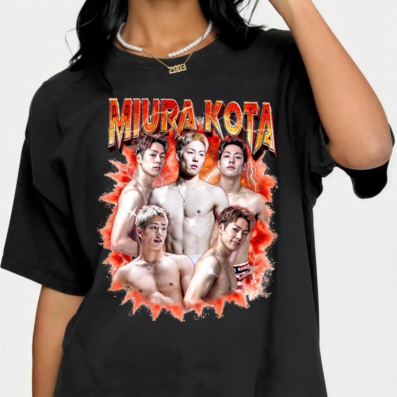 May include: Black t-shirt featuring a graphic of five shirtless men with the text "MIURA KOTA" in a gold and orange font. The graphic has a red and orange burst design around the men.