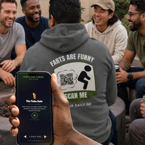 May include: A dark gray hooded sweatshirt featuring a graphic on the back with the text "FARTS ARE FUNNY" and "SCAN ME" above and below a QR code and a stick figure. A smartphone screen displays the text "FARTS ARE FUNNY" and "The Tuba Solo".