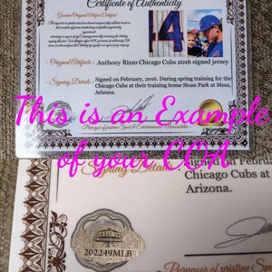 May include: A white certificate of authenticity with brown decorative borders, featuring the text Certificate of Authenticity, details about an Anthony Rizzo signed Chicago Cubs jersey, a photo of the player, and a holographic seal with 202249MLB.