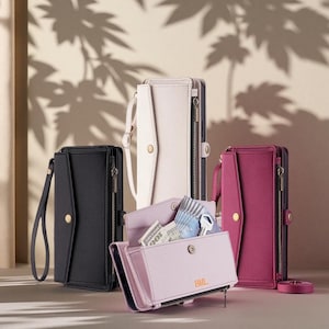 May include: A collection of four rectangular phone wallet cases in black, white, magenta, and light purple. Each case features a wrist strap, a snap-button closure, and a side zipper. The light purple case is open, revealing cards and cash.