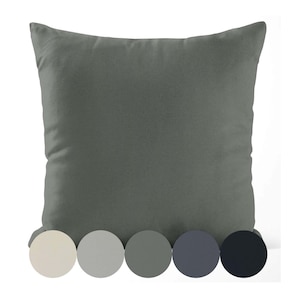 May include: A square, solid gray pillow with a soft texture. Below the pillow are five color swatches in cream, light gray, medium gray, dark gray, and black, offering color options. The pillow is designed for home decor.