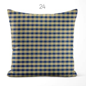 May include: A square throw pillow featuring a blue and beige checkered gingham pattern. The number 24 is printed in black above the pillow. The fabric has a visible woven texture throughout the design, creating a consistent grid of alternating colors.