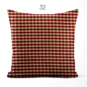 May include: A square throw pillow featuring a red and cream-colored gingham check pattern. The pillow is labeled with the number 32 at the top center. The fabric displays a consistent grid of small, repeating squares across the entire surface.