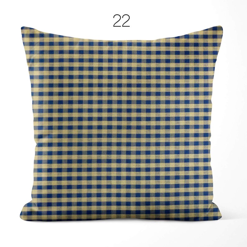 May include: A square throw pillow featuring a classic navy blue and beige gingham check pattern. The design consists of a repeating grid of small, uniform squares across the entire surface. The number 22 is printed in black above the pillow.