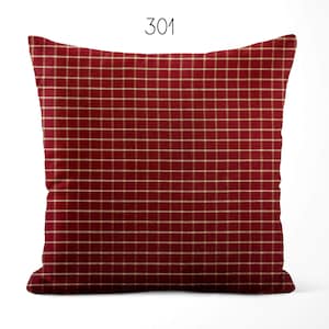 May include: A square throw pillow featuring a deep red fabric base with a thin, light beige grid pattern throughout. The number 301 is printed in black at the top center above the pillow. The pillow has a standard square shape with rounded corners.