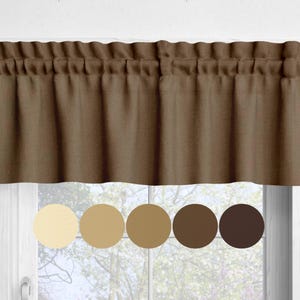 May include: A brown valance curtain with a gathered top, hanging above a window. Below the valance are five color swatches in shades of beige and brown, showcasing color options. The curtain is made of a textured fabric.