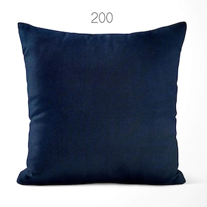 May include: A square throw pillow in a solid dark navy blue color with a smooth, uniform fabric texture. The number 200 is printed in a simple black font centered above the top edge of the pillow, which features clean, straight stitched seams.