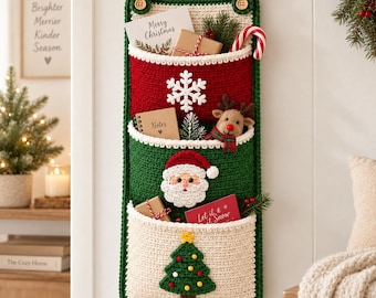May include: A vertical three-pocket crochet wall organizer featuring a red top pocket with a white snowflake, a green middle pocket with a Santa Claus face, and a cream bottom pocket with a green Christmas tree. It hangs from a wooden rod.