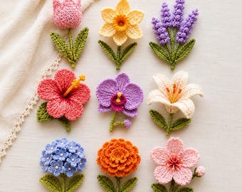 May include: A collection of nine crocheted flower appliques arranged in a grid. The set includes a pink tulip, yellow daffodil, purple lavender, red hibiscus, purple orchid, white lily, blue hydrangea, orange marigold, and a light pink cherry blossom.