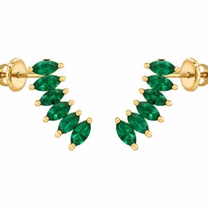 May include: A pair of gold ear climbers featuring five marquise-cut green stones arranged in a curved, ascending line. Each earring includes a threaded post and a matching gold screw-back closure, designed to follow the natural curve of the earlobe.