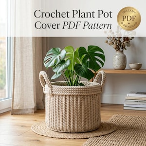 May include: A beige crochet plant pot cover with a ribbed texture and two side handles. The text "Crochet Plant Pot Cover PDF Pattern" and a gold "Instant PDF Download" badge are visible at the top of the image, with a green plant inside.