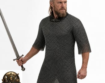 May include: A silver-colored metal chainmail hauberk featuring half-length sleeves and a black collar with a buckle closure. The garment is worn with a long, straight steel sword held in the right hand. The chainmail consists of interlocking rings.