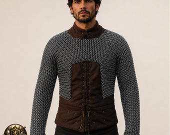 May include: A silver-colored chainmail coif or mantle featuring interlocking metal rings, worn over a dark brown long-sleeved tunic with a front lace-up closure. The chainmail covers the shoulders and upper chest, extending down to the long sleeves.