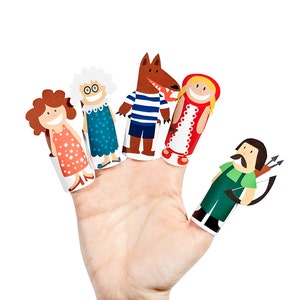 May include: Five finger puppets depicting characters from the fairy tale Little Red Riding Hood. The puppets are made of paper and feature a wolf, a grandmother, Little Red Riding Hood, and a huntsman.