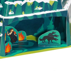 Puede incluir: Una ilustraci&oacute;n de libro desplegable de una cueva con fuego, una persona con un bast&oacute;n y tres lobos negros. La cueva est&aacute; hecha de papel y tiene un esquema de color verde y azul.