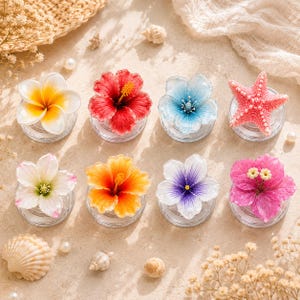 May include: A set of eight decorative resin pieces featuring various floral and marine designs, including hibiscus flowers in red, orange, and pink, a white and yellow plumeria, blue and purple blossoms, and a textured pink starfish, all on clear bases.