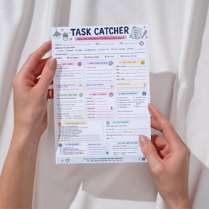 May include: A white paper task planner sheet titled TASK CATCHER with colorful pastel sections for organizing projects. The layout includes numbered fields for steps, priority, timing, and follow-up, featuring small icons like a lamp, plant, and pen.