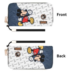 May include: A zip-around wallet featuring Mickey Mouse. The front has a large Mickey Mouse graphic and a pattern of Mickey Mouse silhouettes on a white background. The back has a similar design. The wallet has a wrist strap and gold-colored zipper.