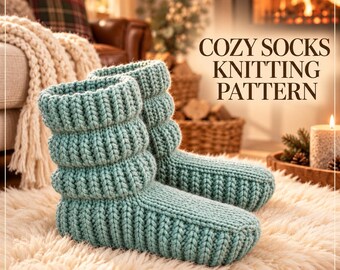 May include: A pair of light teal knitted slipper socks with a thick ribbed cuff and textured stitch pattern. The text COZY SOCKS KNITTING PATTERN is displayed in dark brown letters on the right side of the image.