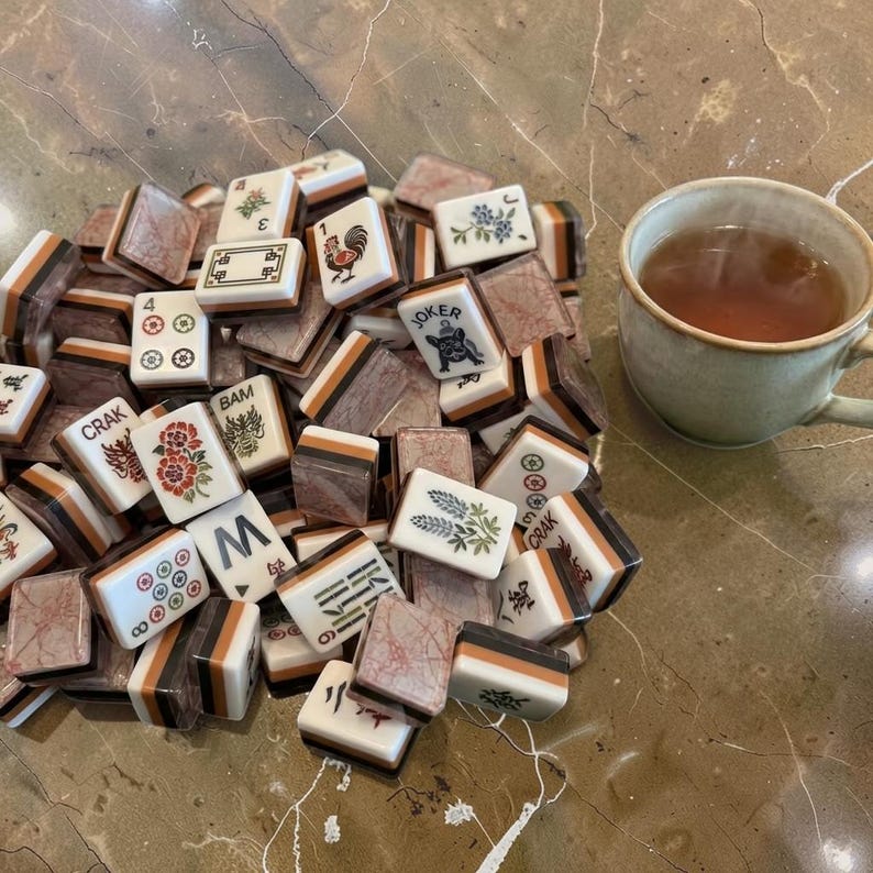 Terracotta Marble Tile Set mahjong tiles scattered with tea cup on green velvet cloth, handmade game set