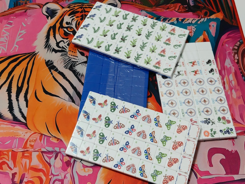 Nature inspired American Mahjong tile set with woodland illustrations, butterfly dot tiles, pine branch bam tiles, firefly mason jar craks, mushroom flower tiles, compass wind tiles, whimsical forest Mahjong set, cottagecore Mahjong tiles, collectible Mahjong game set, luxury Mahjong tiles, aesthetic board game décor, botanical Mahjong collection, artistic Mahjong gift for nature lovers and cozy game nights