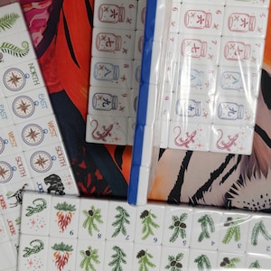 Nature inspired American Mahjong tile set with woodland illustrations, butterfly dot tiles, pine branch bam tiles, firefly mason jar craks, mushroom flower tiles, compass wind tiles, whimsical forest Mahjong set, cottagecore Mahjong tiles, collectible Mahjong game set, luxury Mahjong tiles, aesthetic board game décor, botanical Mahjong collection, artistic Mahjong gift for nature lovers and cozy game nights
