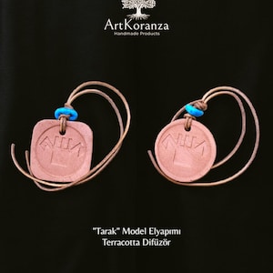 May include: Two terracotta diffusers, one square and one circular, with brown leather cords and blue accents. The diffusers feature an embossed design and are set against a black backdrop. The text "Tarak Model Elyapımı Terracotta Difüzör" is visible below.