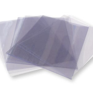 May include: A stack of multiple clear, rectangular plastic document sleeves arranged in a fan-like pattern. Each sleeve is transparent, smooth, and features an open edge for inserting papers, providing a protective cover for standard documents.