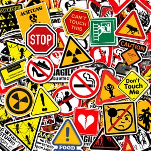 May include: A collage of warning and safety stickers in various shapes and sizes. The stickers display a range of symbols and text, including "STOP," "ACHTUNG," and "CAUTION." Designs include a radiation symbol, a no smoking sign, and a broken heart. The stickers are in various colours.