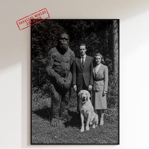 May include: Monochrome framed print depicting a family portrait with a person in a gorilla suit, a man in a suit, a woman in a suit, and a golden Labrador. The print has the text "PARALLEL WORLDS ARCHIVE".