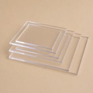 May include: A stack of clear, rectangular acrylic sheets. The sheets are transparent, allowing the background to be visible. The edges of the sheets are smooth and the overall appearance is clean and modern.