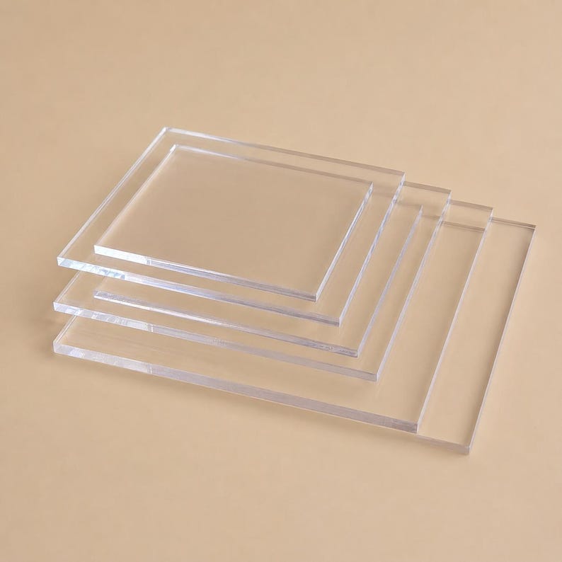 May include: A stack of clear, rectangular acrylic sheets. The sheets are transparent, allowing the background to be visible. The edges of the sheets are smooth and the overall appearance is clean and modern.
