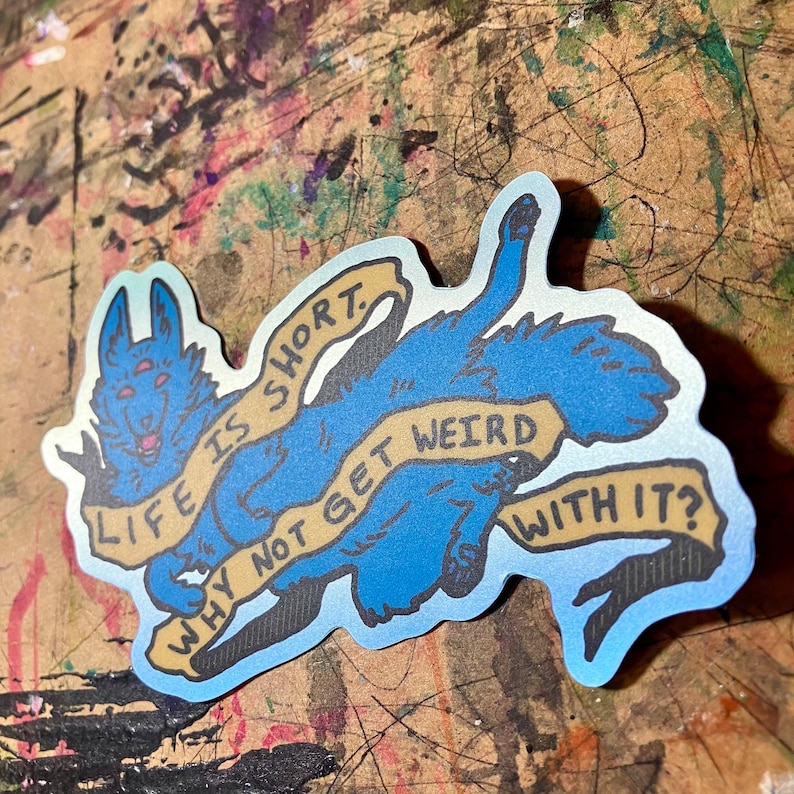 May include: A blue and yellow sticker with a cartoon wolf holding a banner that reads "Life is short. Why not get weird with it?"