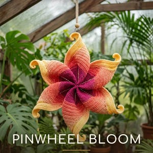 May include: A crochet pinwheel bloom wind spinner with a gradient of yellow, orange, and magenta yarn. The hanging decoration features a six-pointed star shape with curled tips. Text reads: PDF CROCHET PATTERN, PINWHEEL BLOOM, WIND SPINNER PATTERN, Fluffy Loop Crafts.