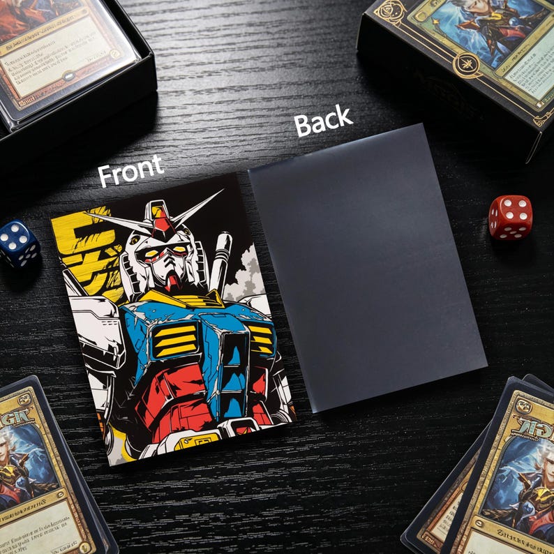 May include: Card sleeve featuring a colorful illustration of a robot with a white face, blue and red accents, and yellow details. The back of the sleeve is solid black. Dice and card boxes are in the background.