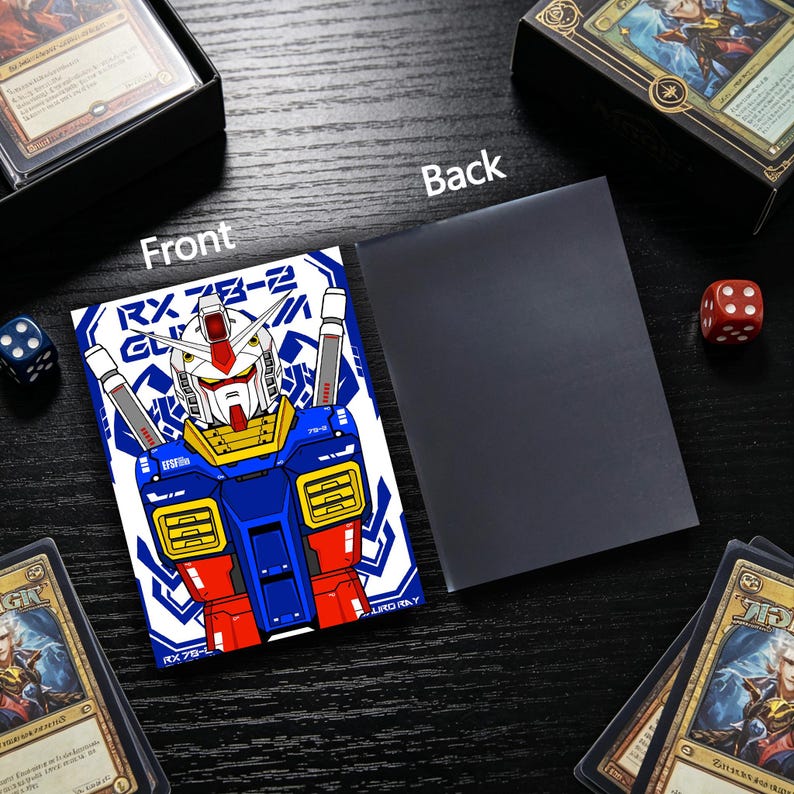 May include: A card sleeve featuring a blue, red, and yellow robot design with the text "RX 78-2". The back of the sleeve is solid black. Dice and card boxes are in the background.