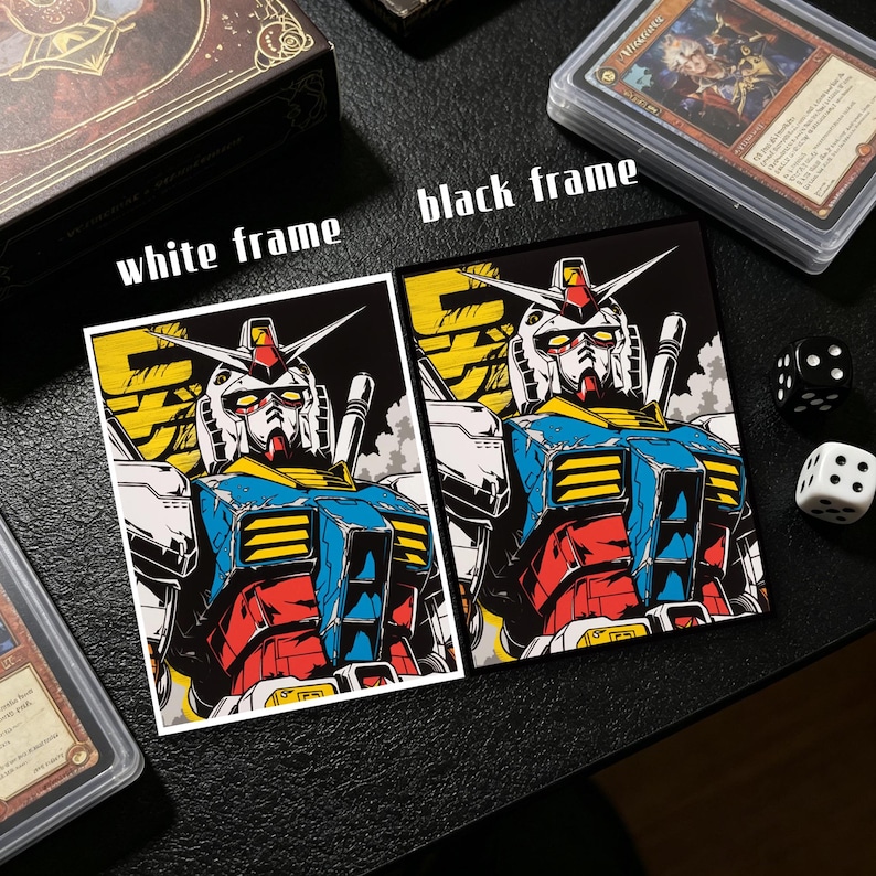 May include: Two trading card sleeves featuring a robot illustration, one with a white frame and the other with a black frame. The robot is primarily blue, red, yellow, and white. Dice and other card sleeves are also visible.