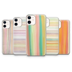 May include: A collection of five phone cases with colorful watercolor designs. The cases feature vertical and horizontal stripes in shades of pink, yellow, green, and orange. The cases are made of clear plastic.