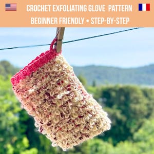 May include: A handmade crochet exfoliating glove, in cream and red, hangs from a clothesline. The glove has a textured surface and a bright pink trim. Text at the top reads "CROCHET EXFOLIATING GLOVE PATTERN" and "BEGINNER FRIENDLY • STEP-BY-STEP".