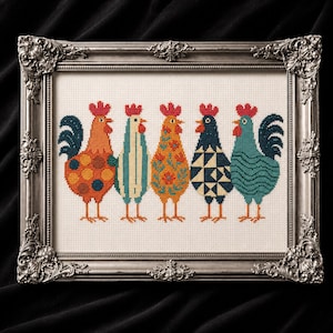 May include: A framed cross-stitch artwork featuring five colorful rooster designs. Each rooster has a unique pattern in shades of orange, blue, and green, with red combs. The artwork is set in a silver ornate frame, perfect for farmhouse decor.