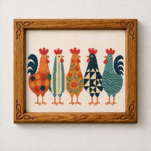 May include: A framed cross-stitch artwork featuring five colorful rooster designs. Each rooster has a unique pattern, including polka dots, stripes, and floral motifs. The frame is made of wood with decorative corner details. The roosters are in shades of orange, blue, and green.