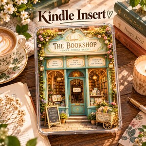 May include: A clear Kindle insert featuring a detailed illustration of a bookshop storefront with teal trim, floral accents, and signs reading The Bookshop, Books Are A Magical Thing, and So Many Books So Little Time, encased in a protective frame.