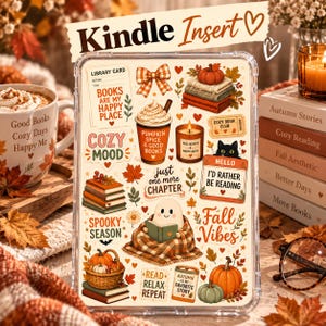 May include: A clear Kindle insert featuring a collage of autumn-themed illustrations including a ghost reading a book, pumpkins, stacks of books, a coffee cup, a candle, and text such as 'Books are my happy place' and 'Fall Vibes' on a cream background.