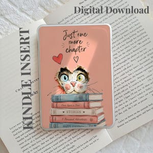 May include: A rectangular Kindle insert featuring a peach-colored background with a cat peeking out from behind a stack of books. The text reads Just one more chapter. The books are labeled Once Upon a Time, STORIES, A Thousand Adventures, and HAPPY ENDINGS.