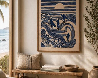 May include: A framed print depicts surfers in a blue and white linocut style. The artwork shows figures walking toward the ocean with surfboards, palm trees, and a setting sun. The print is displayed above a wooden bench with books and a bowl.