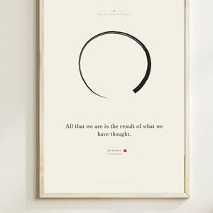 May include: A framed wall art print on a cream background featuring a black hand-drawn circle, the text "THE FLOATING WORLD", the quote "All that we are is the result of what we have thought.", and the attribution "BUDDA The Dhammapada".