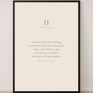 May include: A framed wall art print featuring a quote by Seneca from Letters to Lucilius on a cream background. The text reads: Nothing, to my way of thinking, is a better proof of a well ordered mind than a man's ability to stop just where he is and pass some time in his own company. The frame is black.