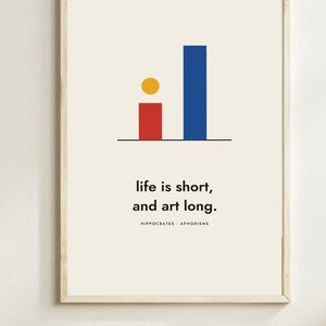 May include: A framed wall art print featuring a cream background with a graphic of a red bar, a blue bar, and a yellow circle above a black horizontal line. Below the graphic, the text reads: life is short, and art long. HIPPOCRATES APHORISMS.
